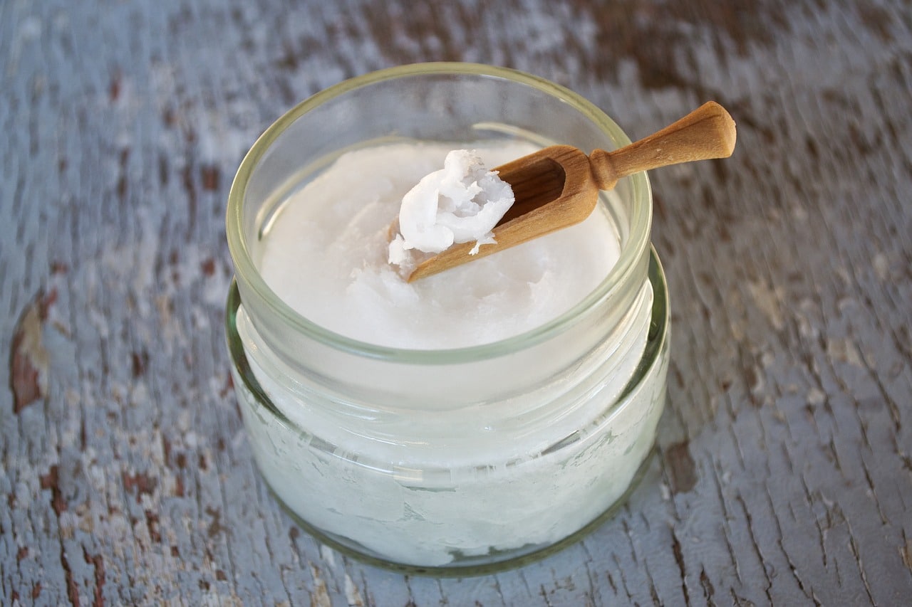 coconut oil on wooden spoon, coconut oil in glass jar, oil